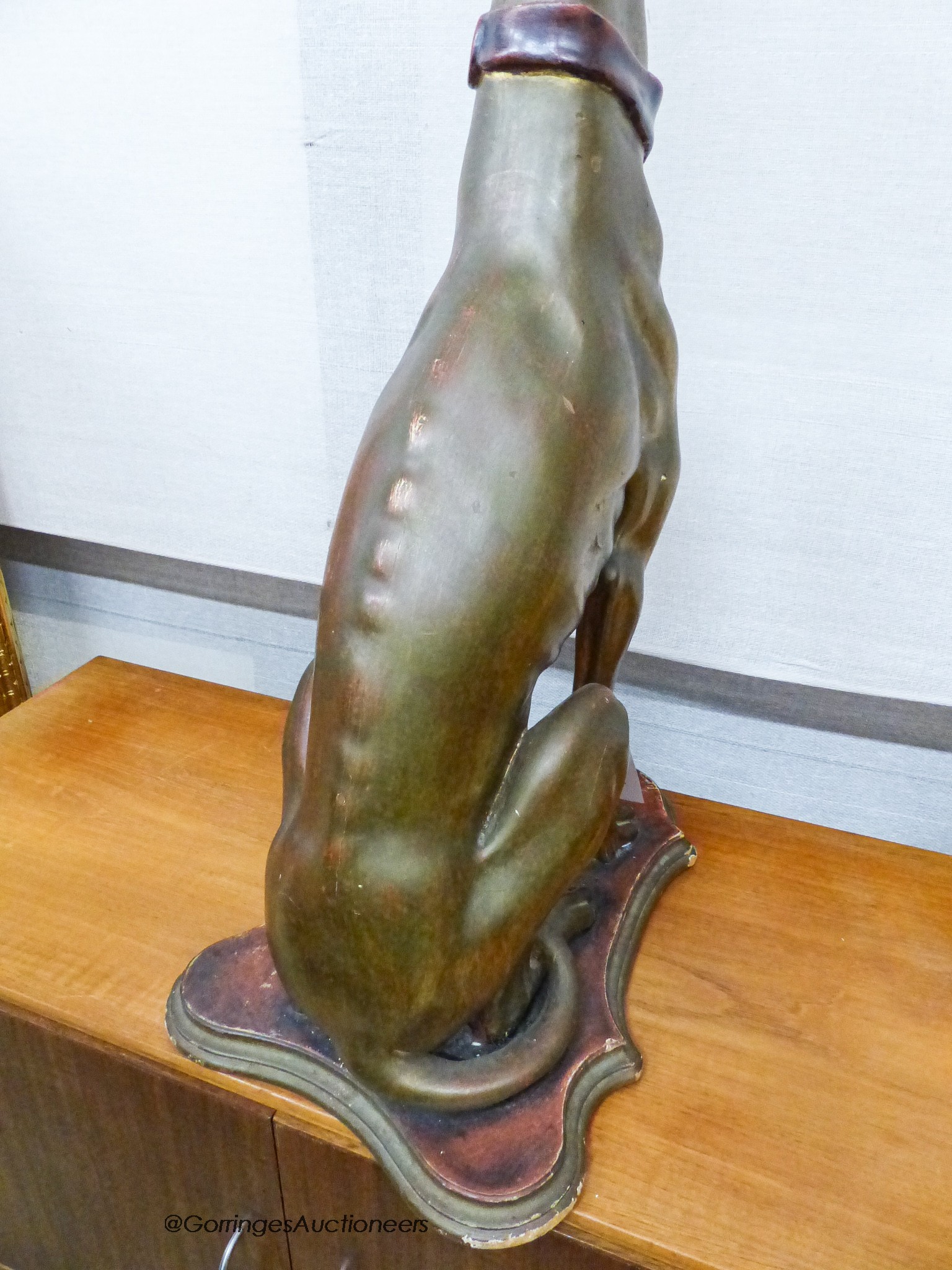 A gilt composition seated greyhound, height 78cm